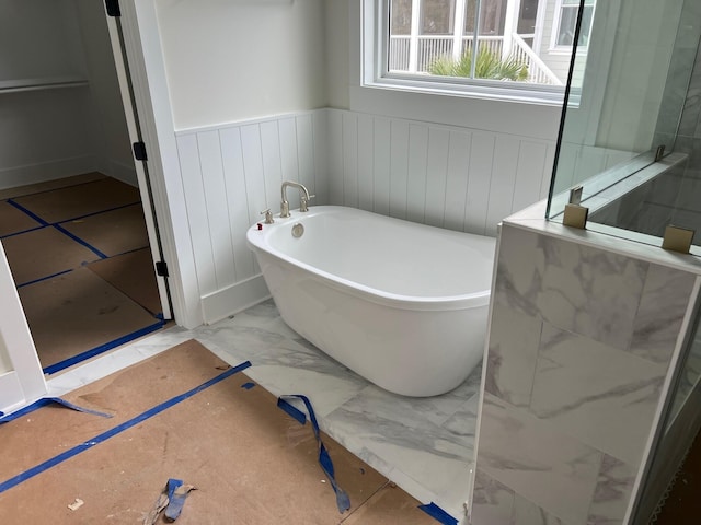 bathroom with a tub to relax in