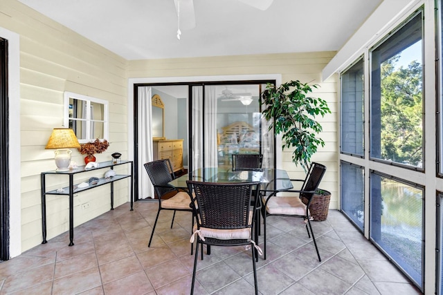 sunroom / solarium featuring ceiling fan