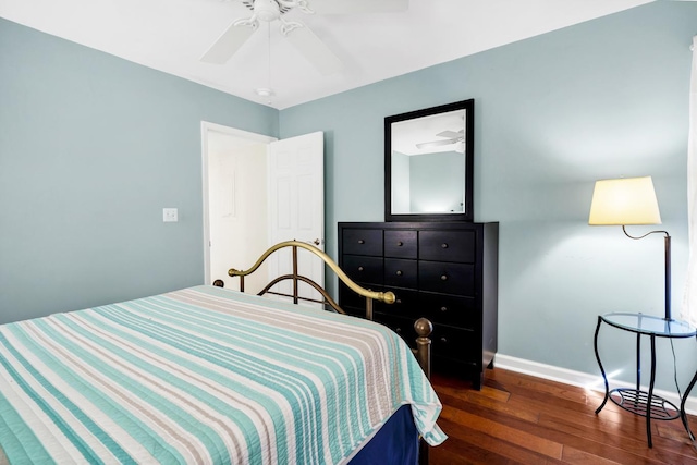 bedroom with dark hardwood / wood-style flooring and ceiling fan