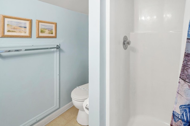 bathroom featuring toilet and a shower with shower curtain