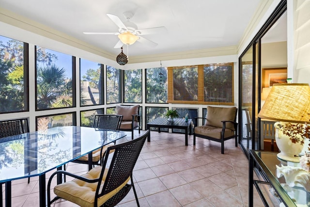 sunroom / solarium featuring ceiling fan