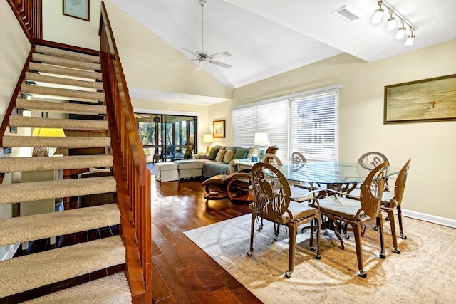 dining area with rail lighting, high vaulted ceiling, hardwood / wood-style floors, and ceiling fan