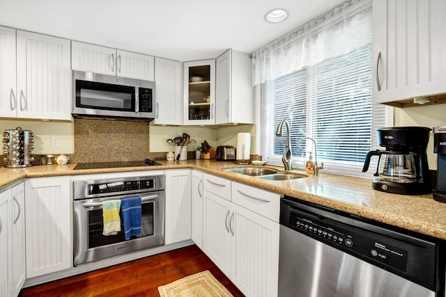 kitchen with dark hardwood / wood-style flooring, sink, white cabinets, and appliances with stainless steel finishes