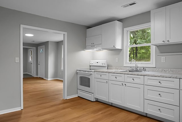 5056 Piedmont Ave, North Charleston, SC 29406 - kitchen with electric range, a sink, light countertops, and white cabinetry
