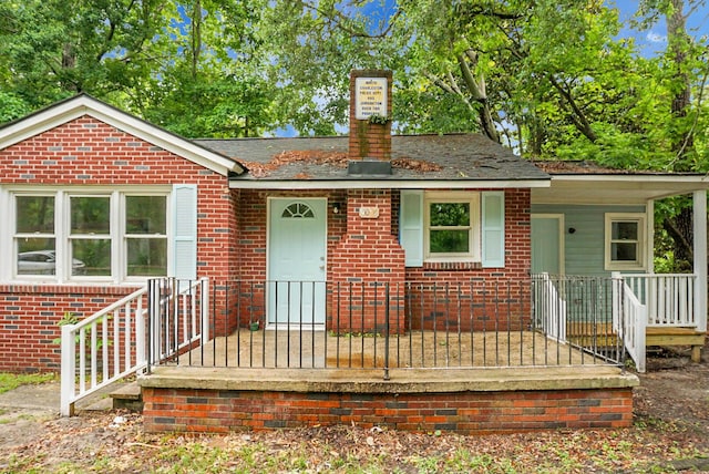 5056 Piedmont Ave, North Charleston, SC 29406 - view of front of property with brick siding, a chimney, and a porch
