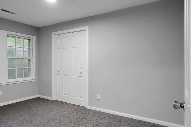 5056 Piedmont Ave, North Charleston, SC 29406 - unfurnished bedroom featuring dark carpet, baseboards, and a closet