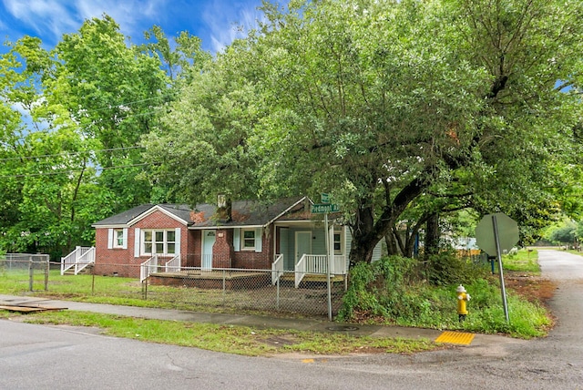 5056 Piedmont Ave, North Charleston, SC 29406 - view of front of property featuring a fenced front yard, brick siding, and covered porch