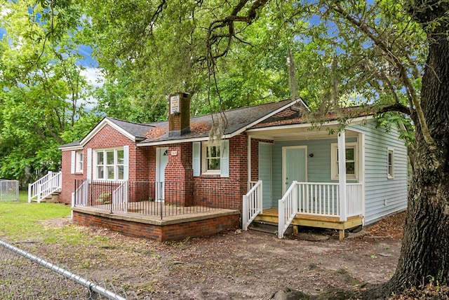 5056 Piedmont Ave, North Charleston, SC 29406 - view of front facade with a chimney, covered porch, and brick siding