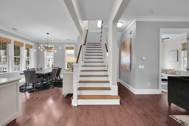 staircase with baseboards, an inviting chandelier, wood finished floors, and crown molding