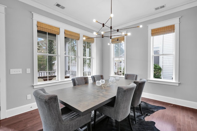 dining space featuring wood finished floors, visible vents, and baseboards