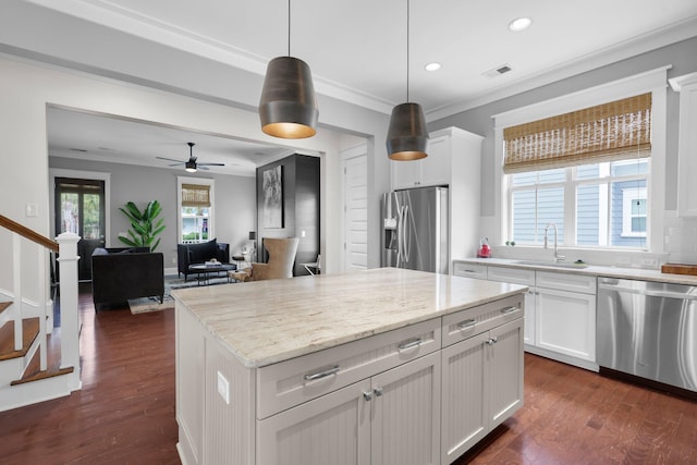 kitchen featuring stainless steel appliances, visible vents, white cabinetry, ornamental molding, and dark wood finished floors