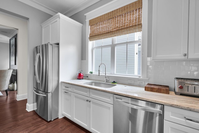 kitchen with white cabinets, appliances with stainless steel finishes, dark wood-style flooring, a sink, and backsplash