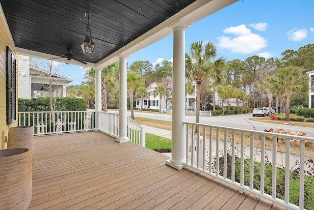 deck with ceiling fan, a residential view, and a porch