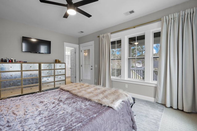 bedroom with ensuite bath, baseboards, visible vents, and a ceiling fan