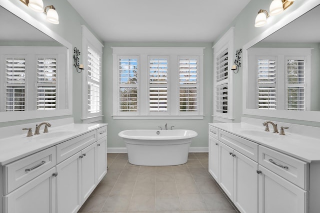 full bath featuring tile patterned flooring, a sink, and a healthy amount of sunlight