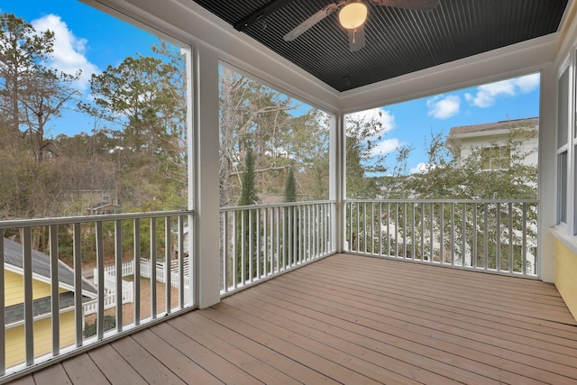 unfurnished sunroom with a ceiling fan