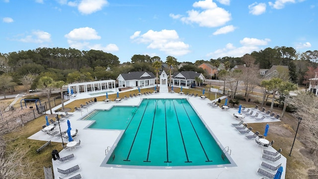 community pool with fence, a pergola, and a patio