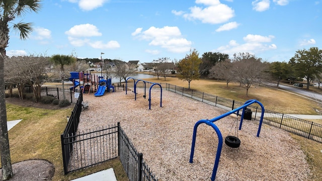 view of community with playground community, fence, and a lawn