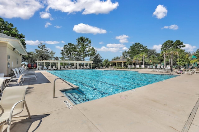 pool featuring a patio and a pergola