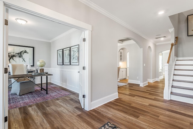 hall featuring ornamental molding and hardwood / wood-style floors