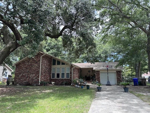 single story home featuring a front lawn and a garage