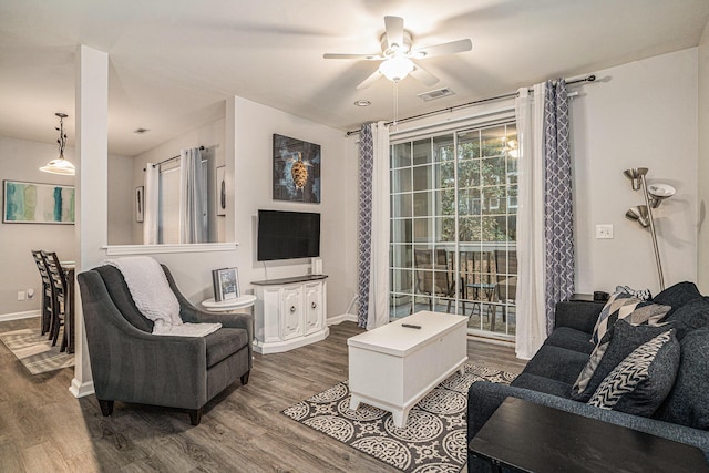 living room featuring dark hardwood / wood-style flooring and ceiling fan