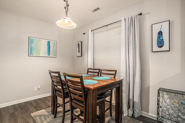 dining area with dark hardwood / wood-style floors