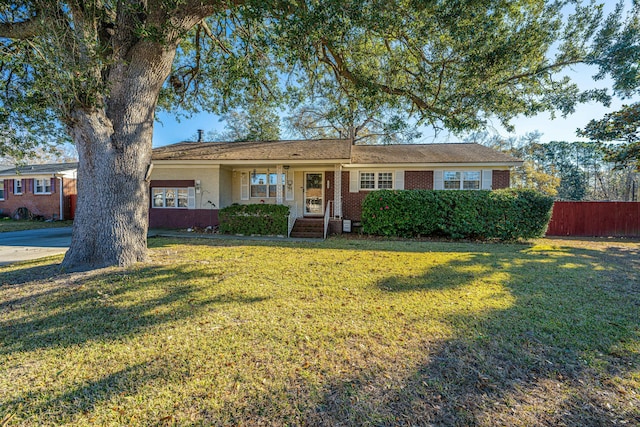 single story home featuring a front yard