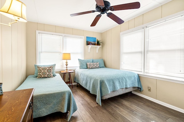 bedroom with ceiling fan, hardwood / wood-style floors, and multiple windows