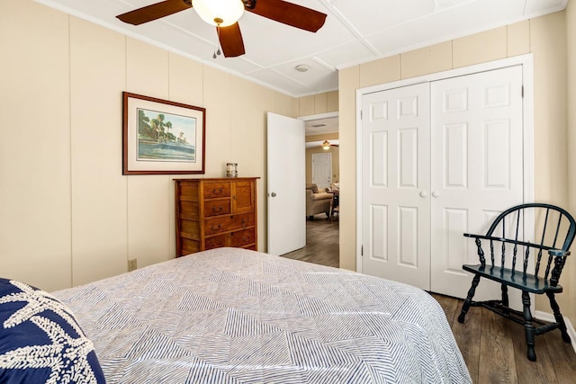 bedroom with crown molding, wood-type flooring, a closet, and ceiling fan