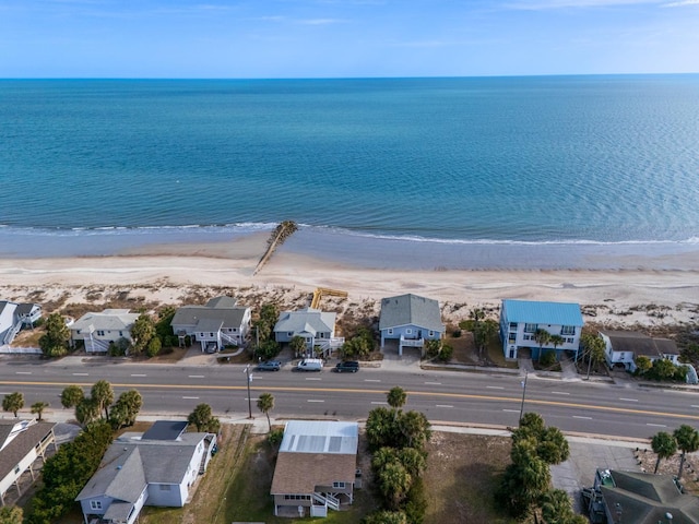 birds eye view of property with a view of the beach and a water view