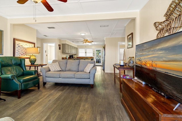 living room featuring ceiling fan and dark hardwood / wood-style flooring