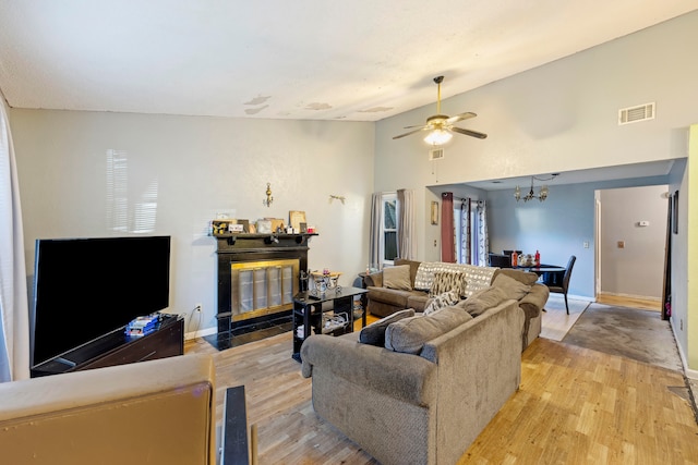 living room with high vaulted ceiling, light wood-type flooring, and ceiling fan