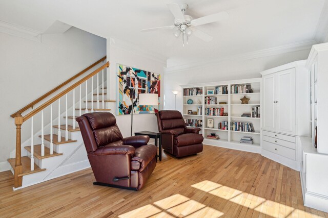 sitting room featuring ceiling fan, ornamental molding, and light hardwood / wood-style floors