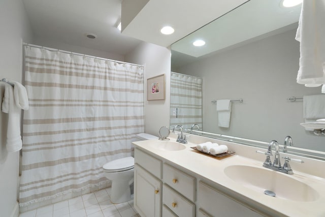 bathroom featuring vanity, tile patterned flooring, and toilet