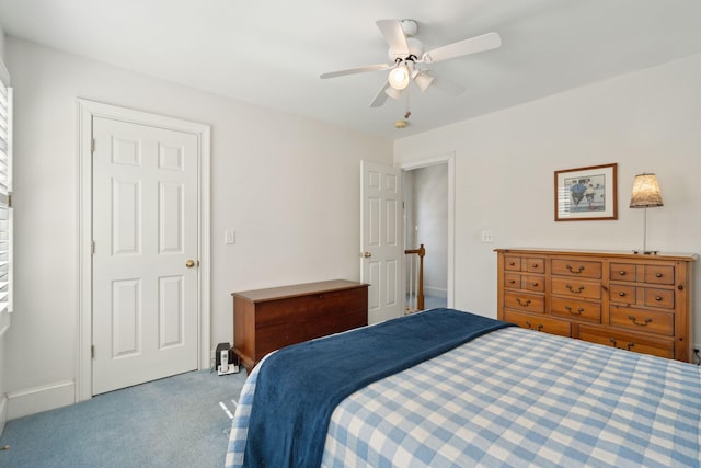 bedroom featuring ceiling fan and carpet