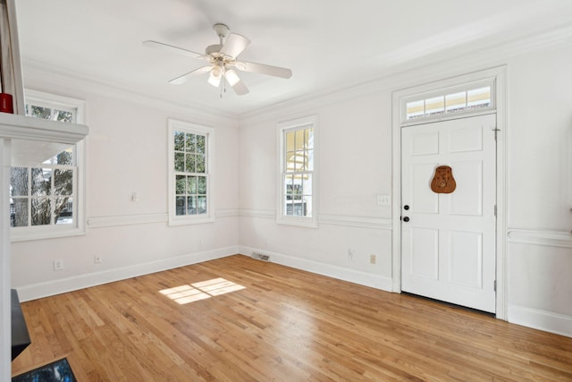 foyer entrance with crown molding, ceiling fan, and light hardwood / wood-style flooring