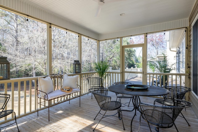 sunroom featuring a healthy amount of sunlight and ceiling fan