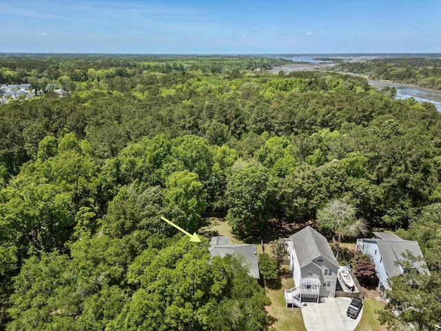 birds eye view of property with a forest view and a water view
