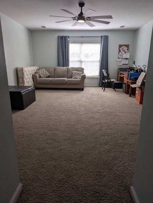 living room featuring ceiling fan and carpet