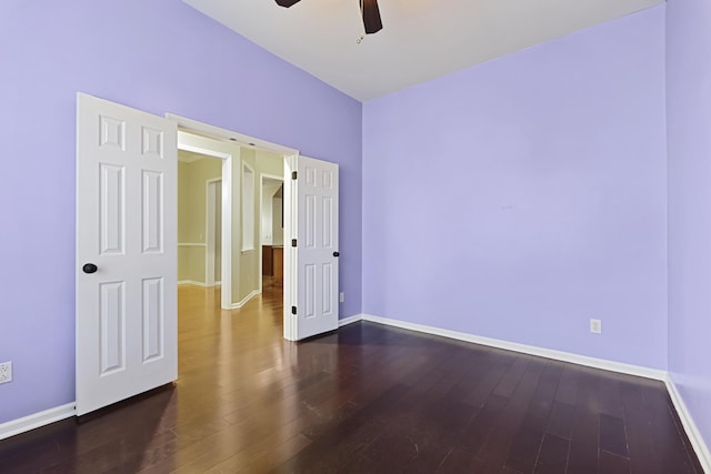 unfurnished bedroom featuring ceiling fan and dark hardwood / wood-style floors