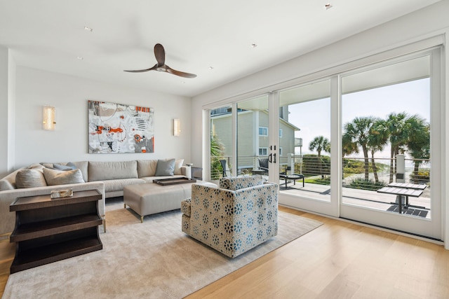 living room with light wood-type flooring and ceiling fan