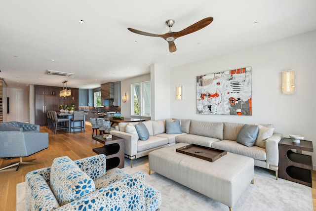 living room featuring light hardwood / wood-style floors and ceiling fan