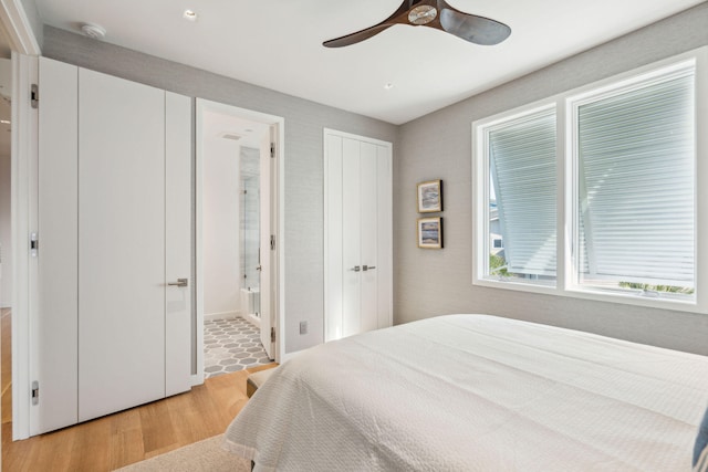 bedroom featuring ensuite bathroom, light hardwood / wood-style floors, and ceiling fan