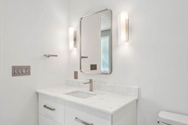 bathroom featuring toilet and vanity