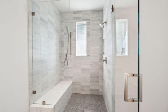 bathroom featuring tile patterned flooring and an enclosed shower