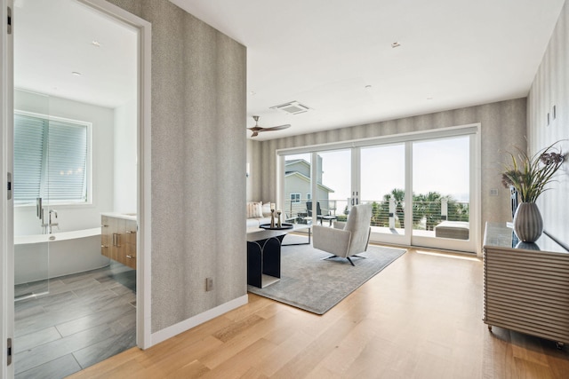 interior space featuring light hardwood / wood-style floors, ceiling fan, and french doors