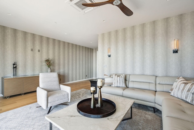 living room featuring ceiling fan and light hardwood / wood-style flooring