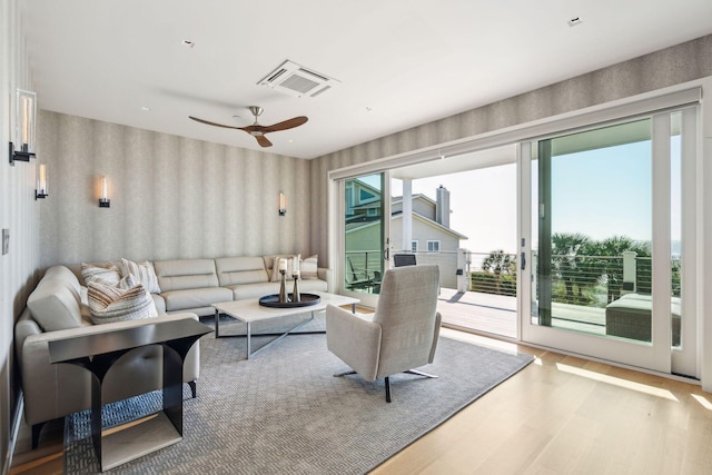 living room featuring hardwood / wood-style flooring and ceiling fan