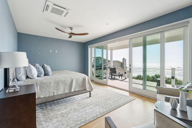 bedroom with access to exterior, light wood-type flooring, multiple windows, and ceiling fan